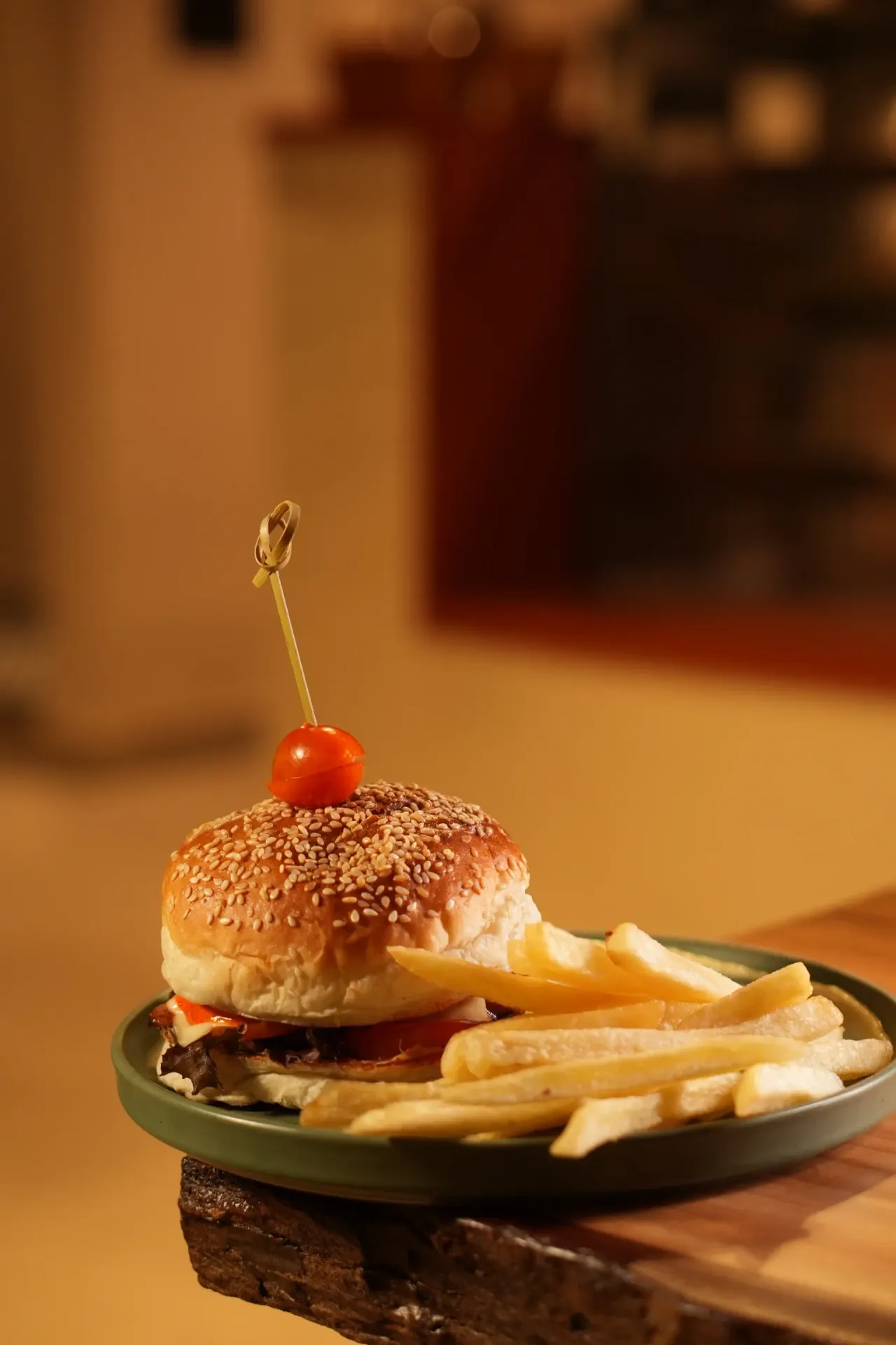 Burger and Fries - A generously layered burger and golden fries in the café's warm evening light.
