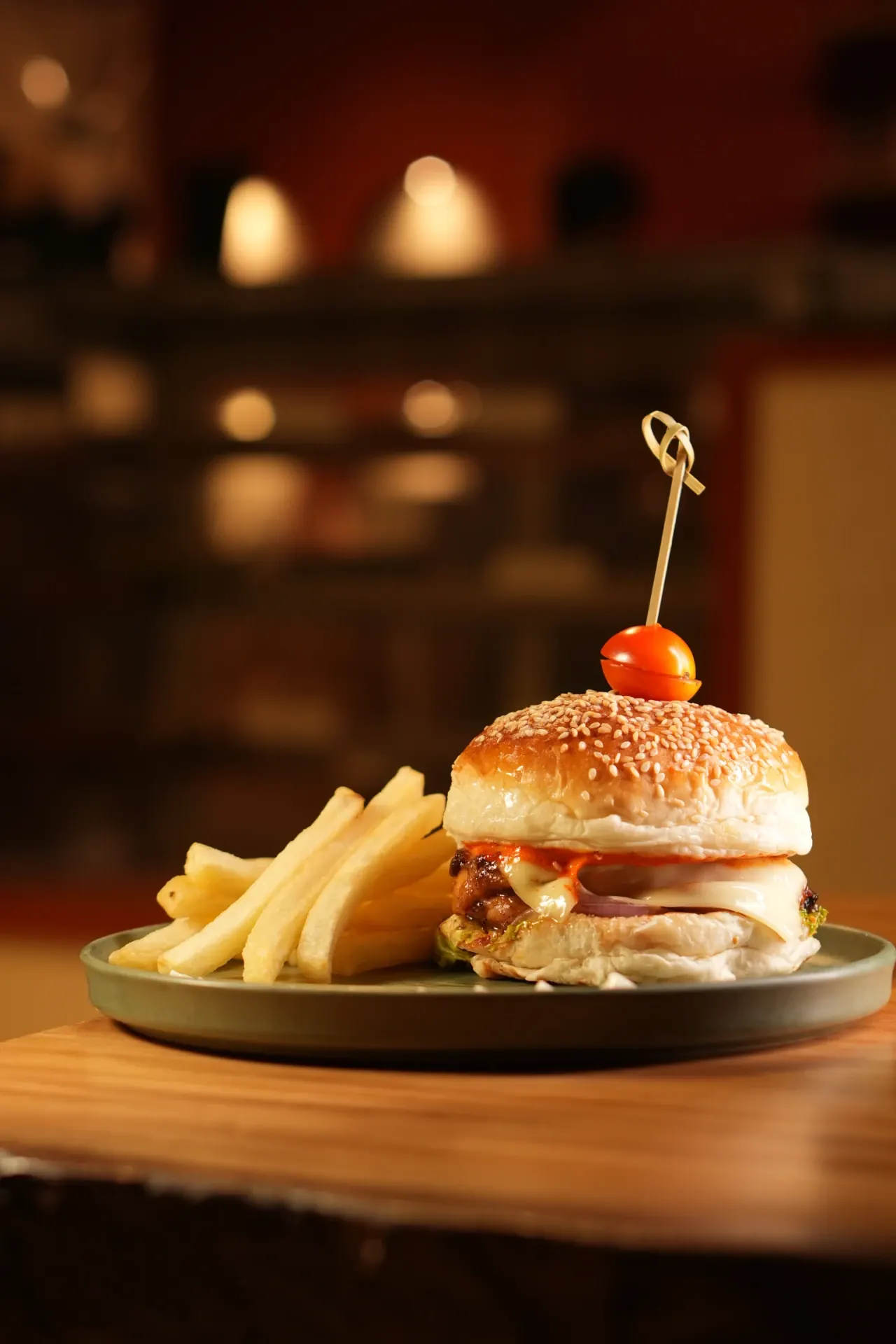 A Proper Café Burger - A sesame-topped burger with crisp fries, plated for a relaxed all-day meal.