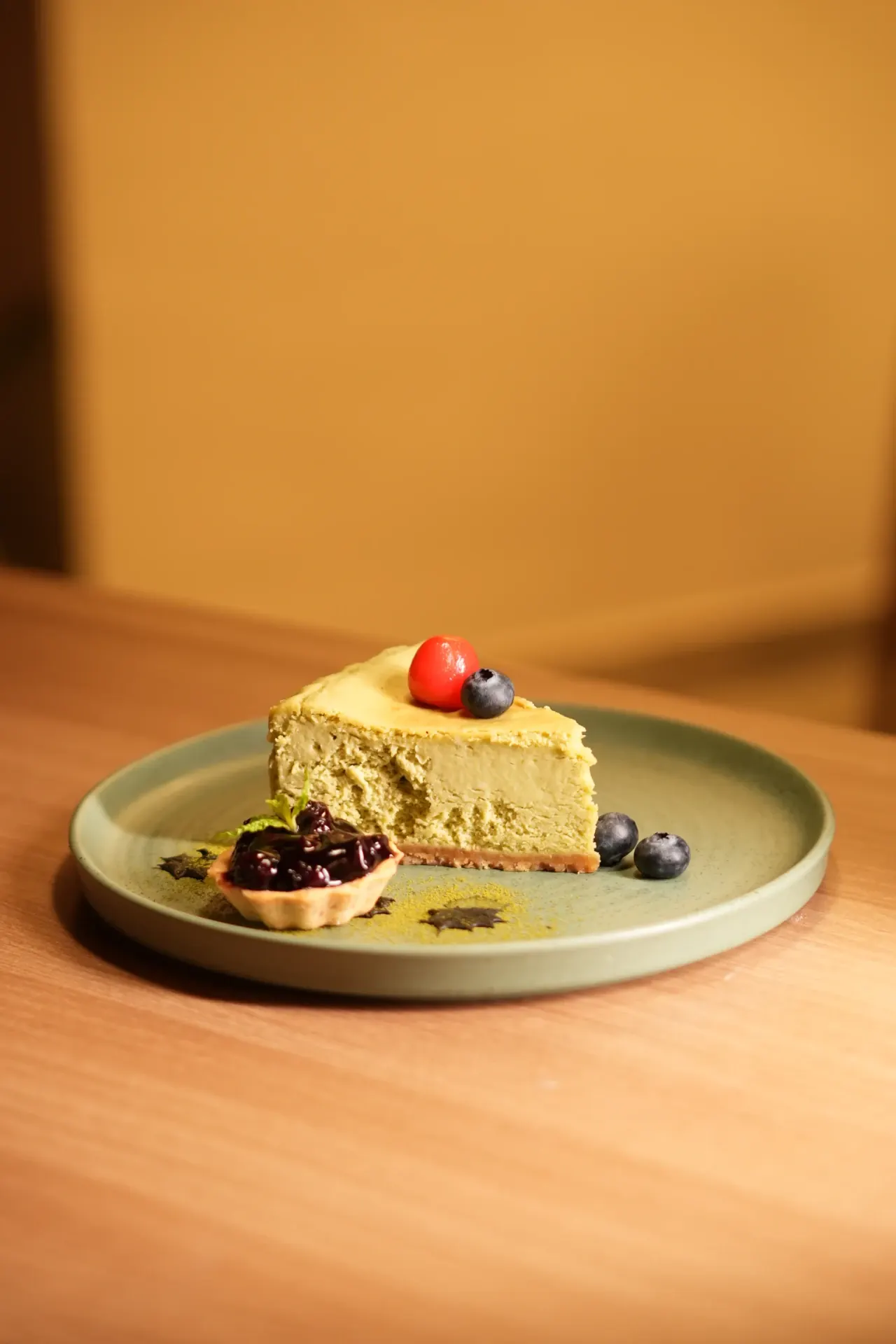 A Sweet Pause - A creamy cheesecake slice finished with berries and a small fruit tart.
